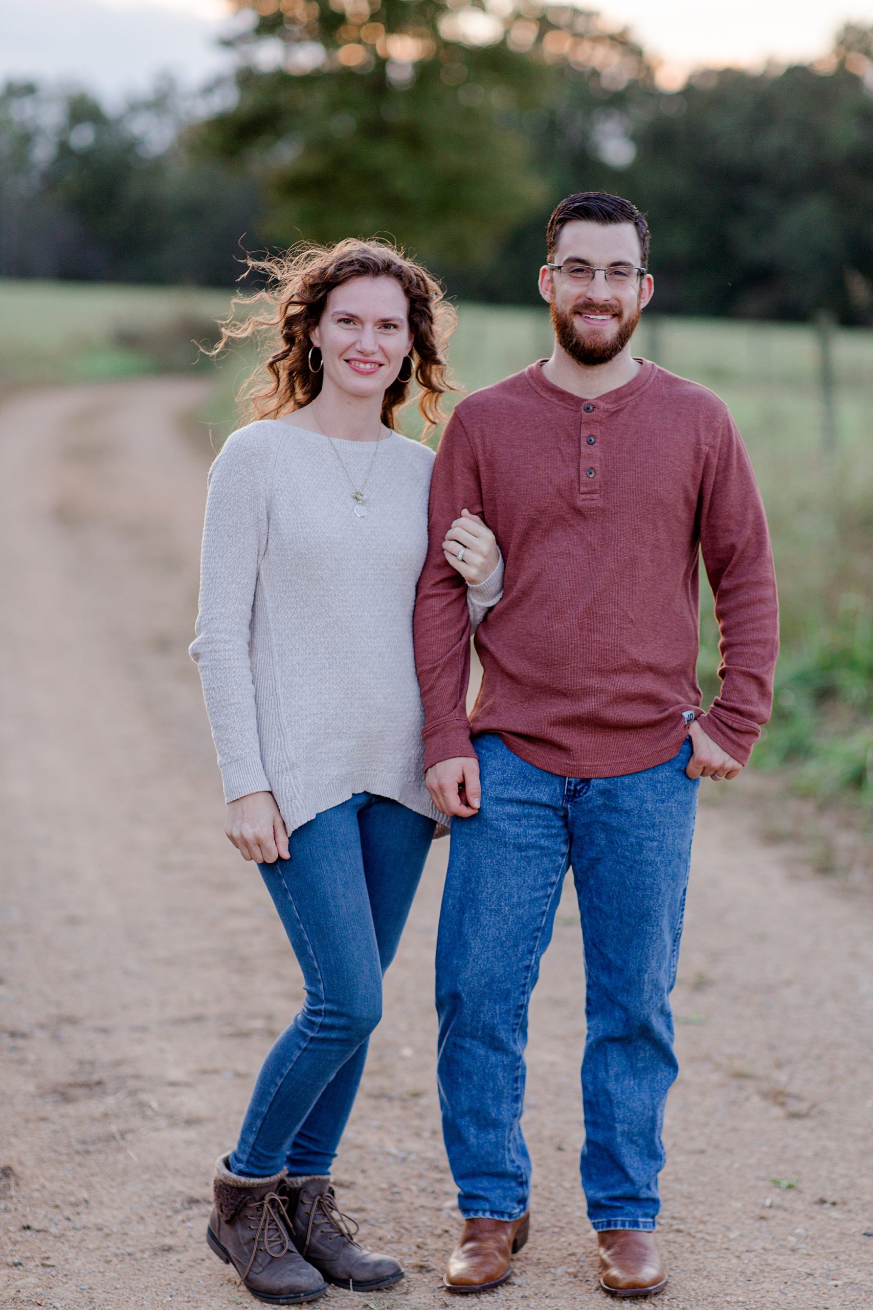 husband and wife stand together in field in Hickman County TN