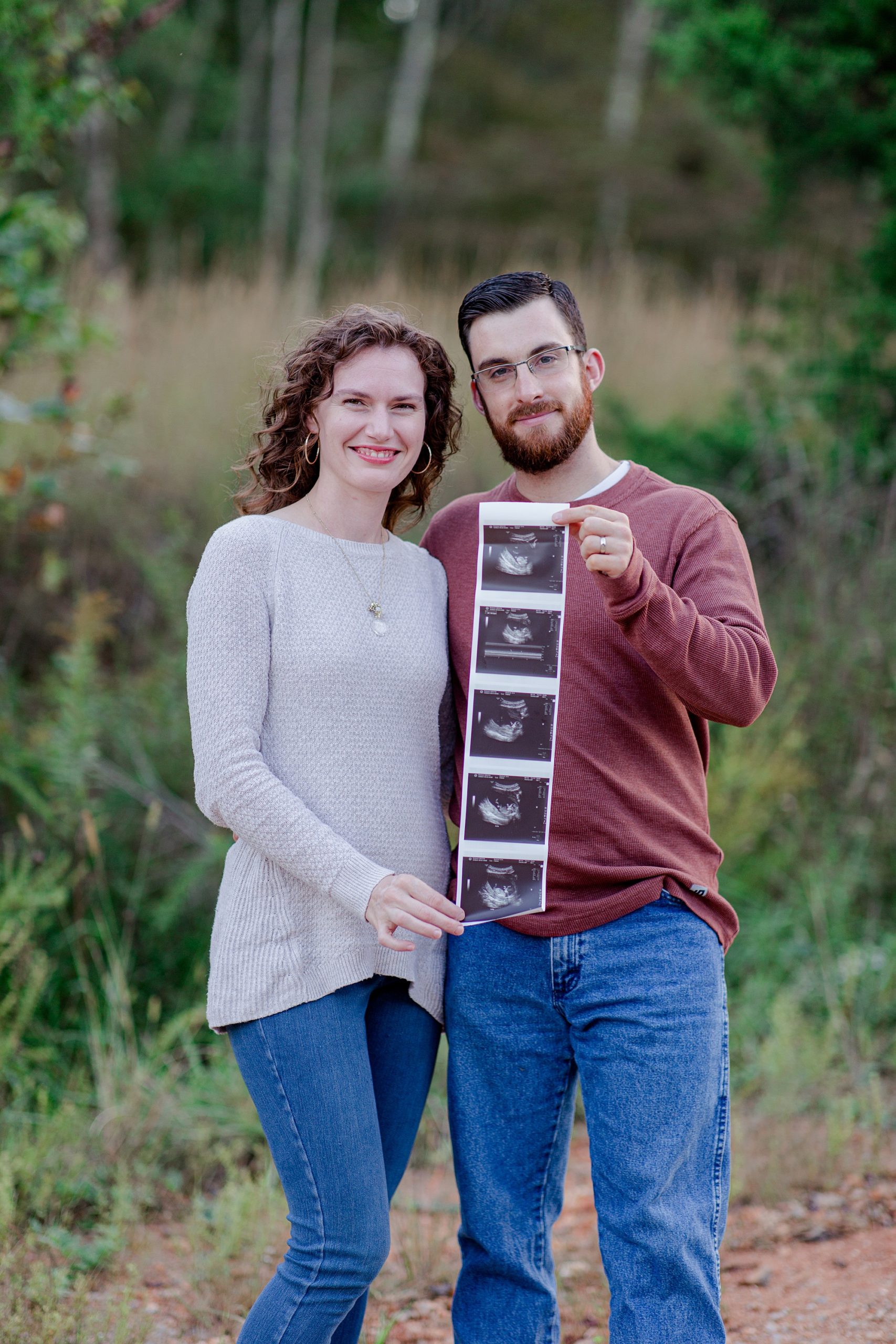 couple holds sonogram during TN pregnancy announcement 