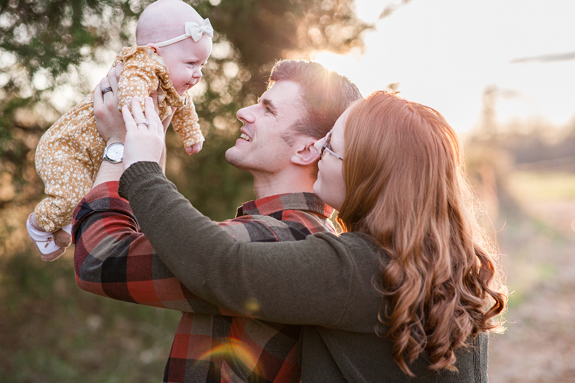 parents look up at baby girl during Family Portraits in Tennessee 