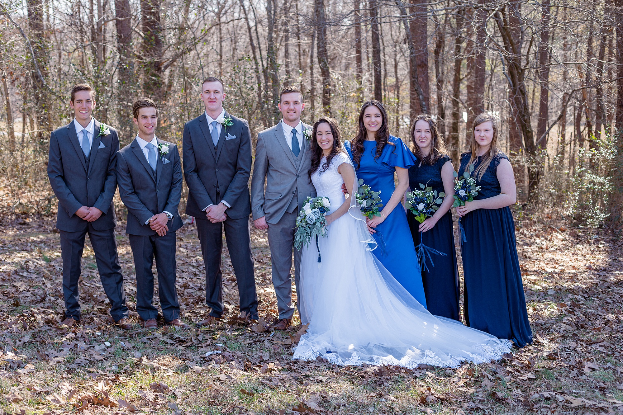 wedding party poses with bride and groom after winter wedding in Middle Tennessee