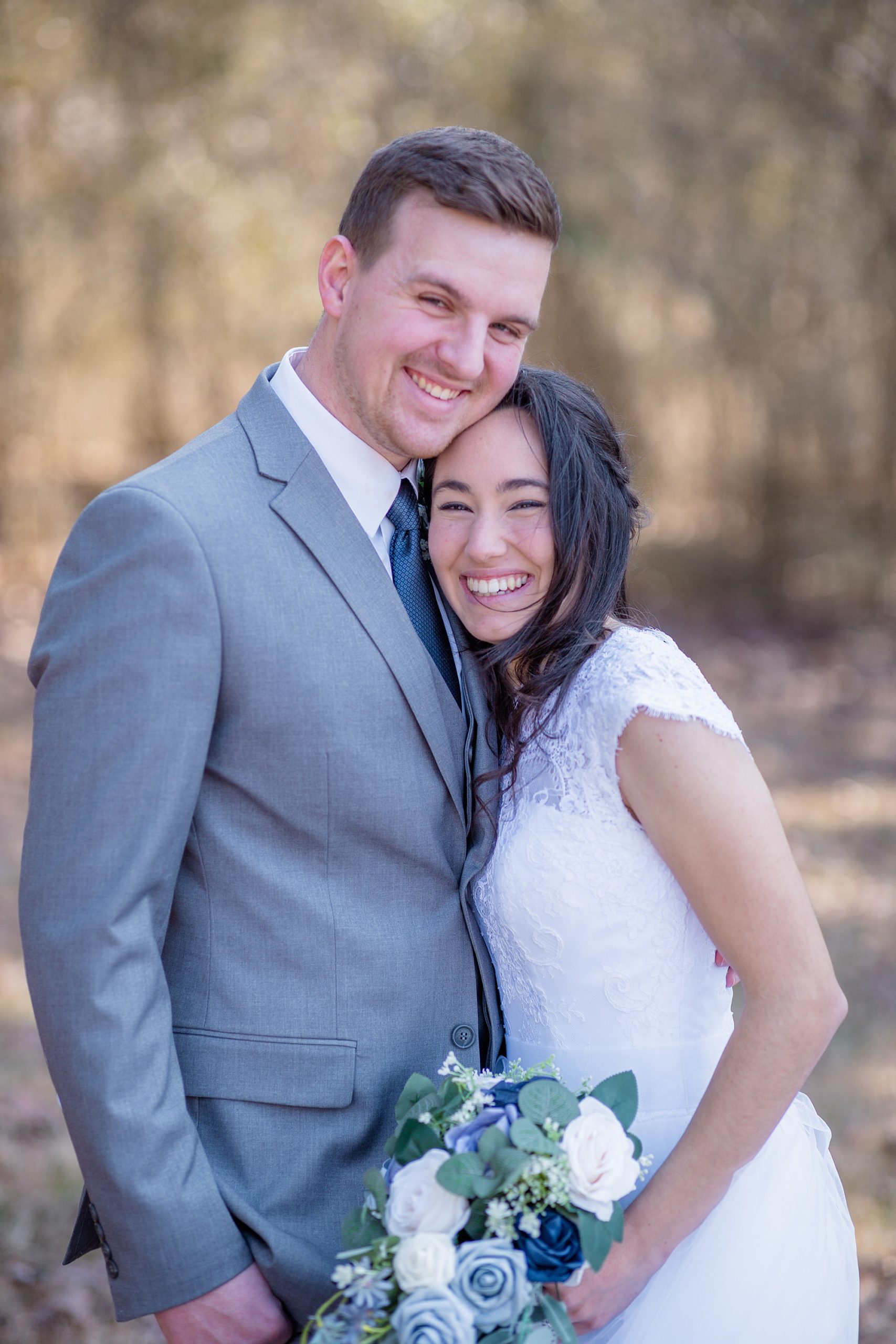 couple hugs during portraits after winter wedding in Middle Tennessee