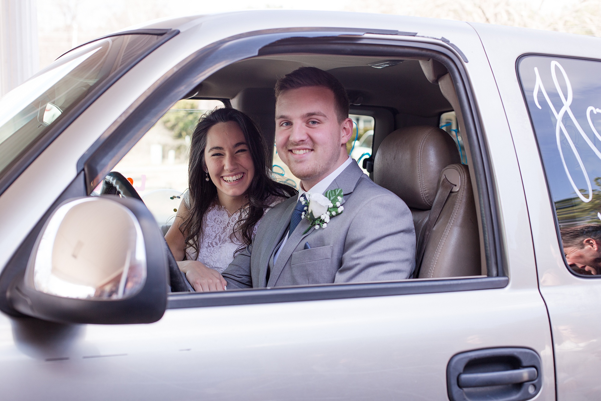 bride and groom drive off from wedding day