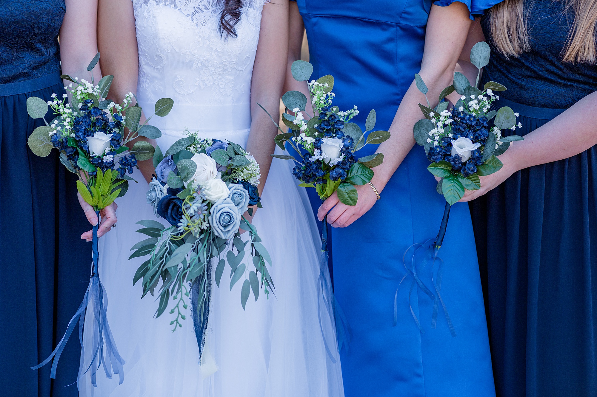 bride holds bouquet with blue flowers for winter wedding in Middle Tennessee