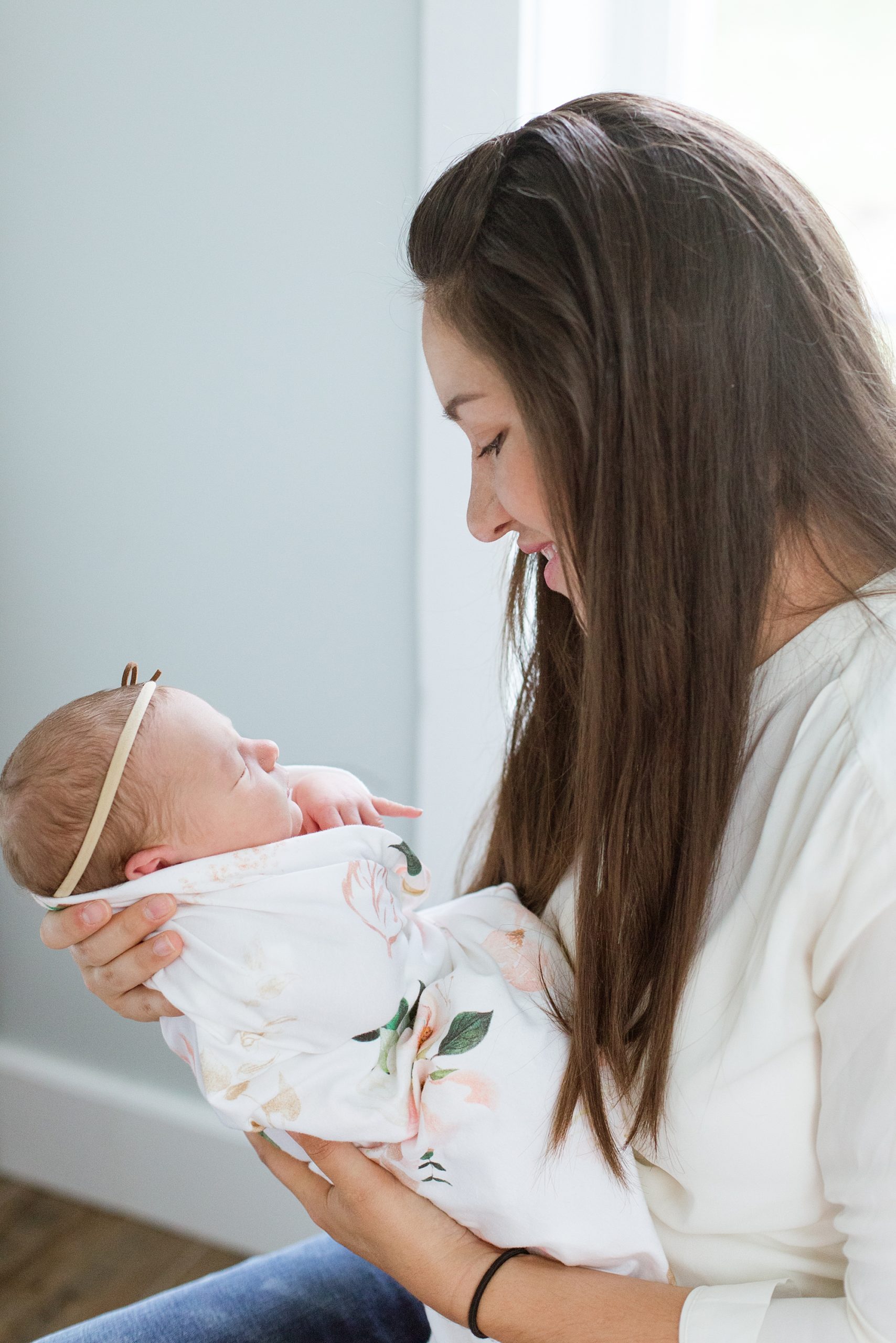 mom holds daughter during lifestyle newborn session
