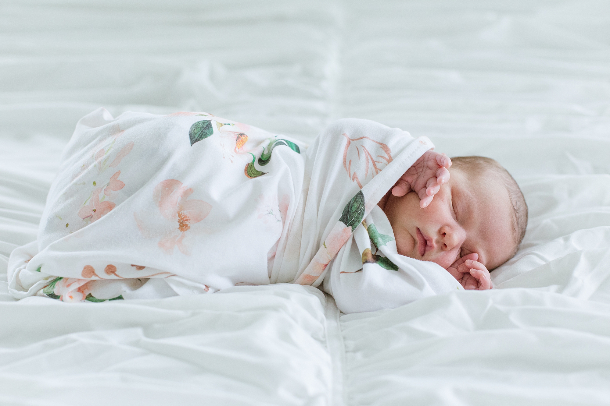 baby girl sleeps in wrap during lifestyle newborn session