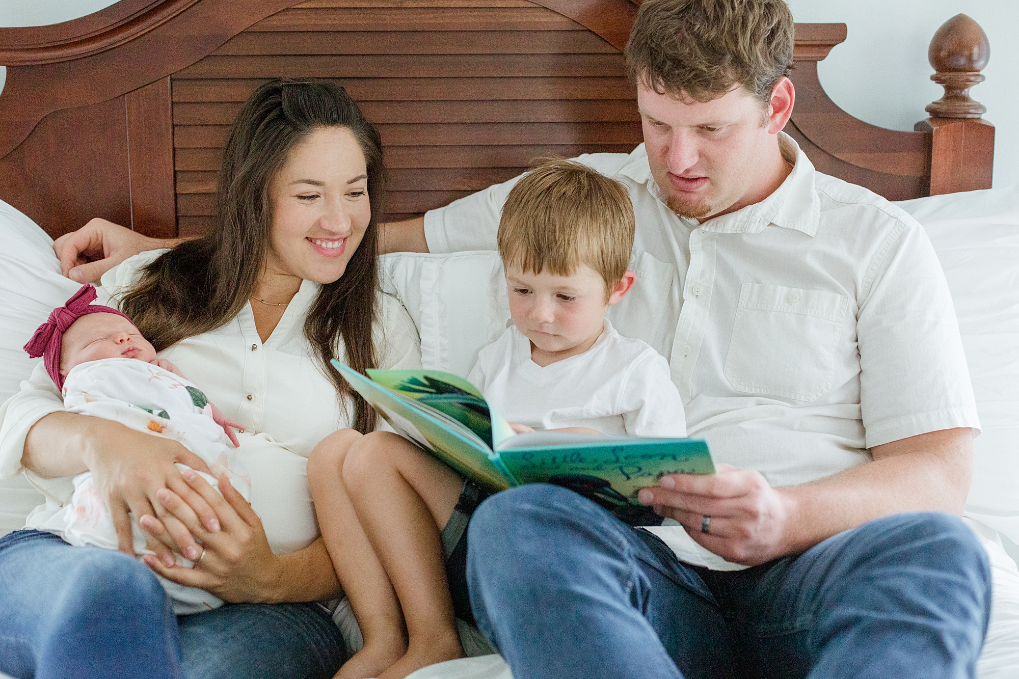 parents read with kids on bed during lifestyle newborn photos